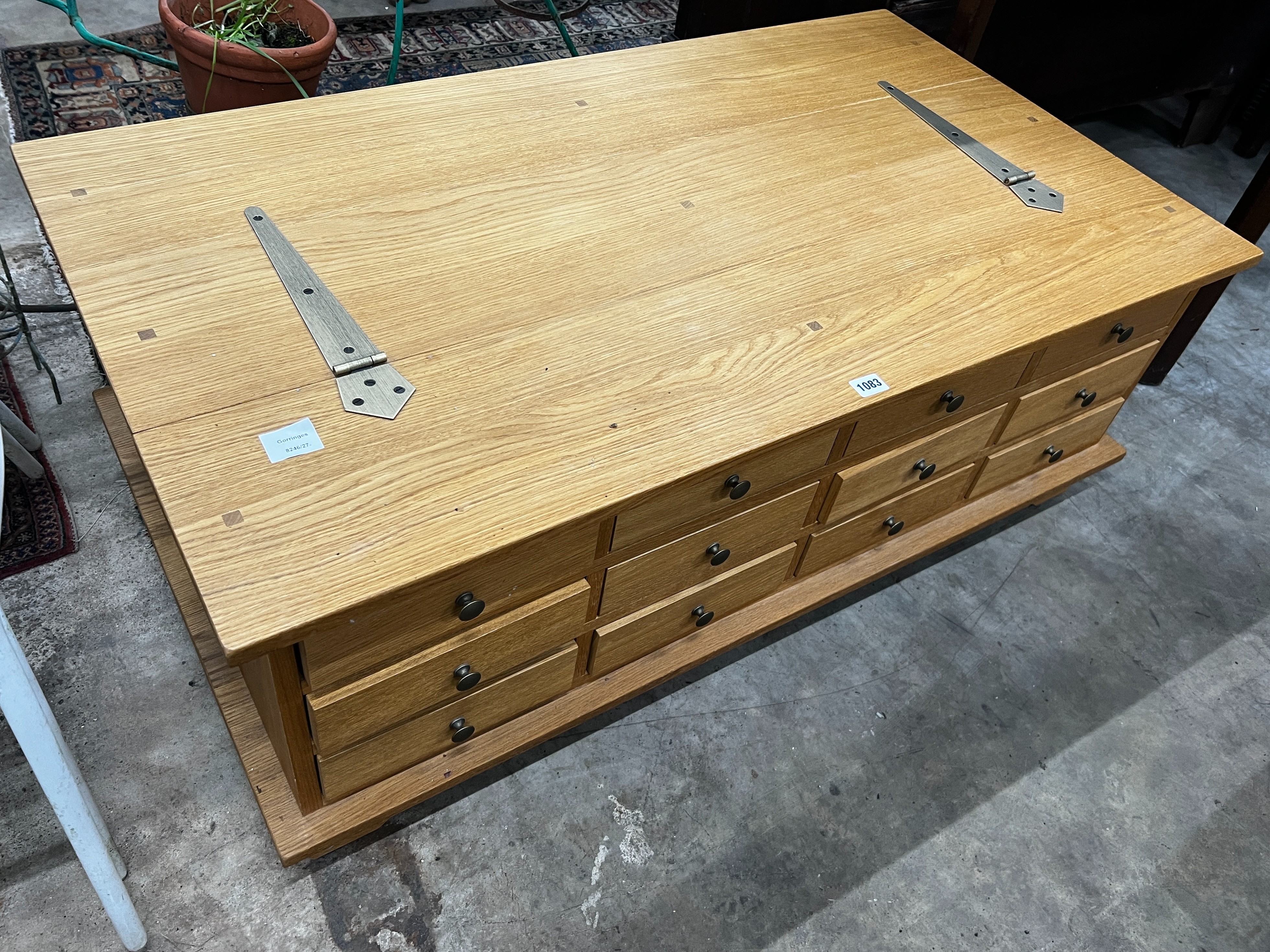 A contemporary Laura Ashley Garrat oak hinged top 12 drawer storage coffee table, length 118cm, depth 66cm, height 44cm